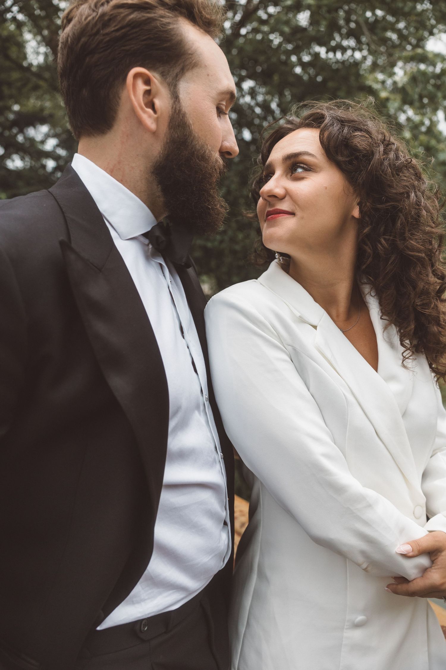 couple smiling at each other during their photoshoot