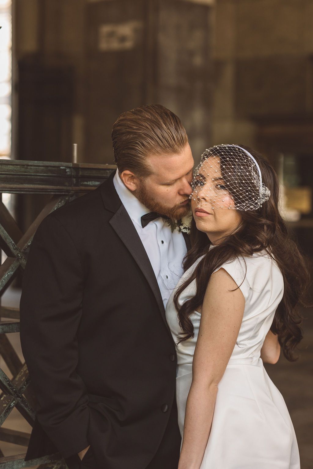 groom kissing the bride on the cheek