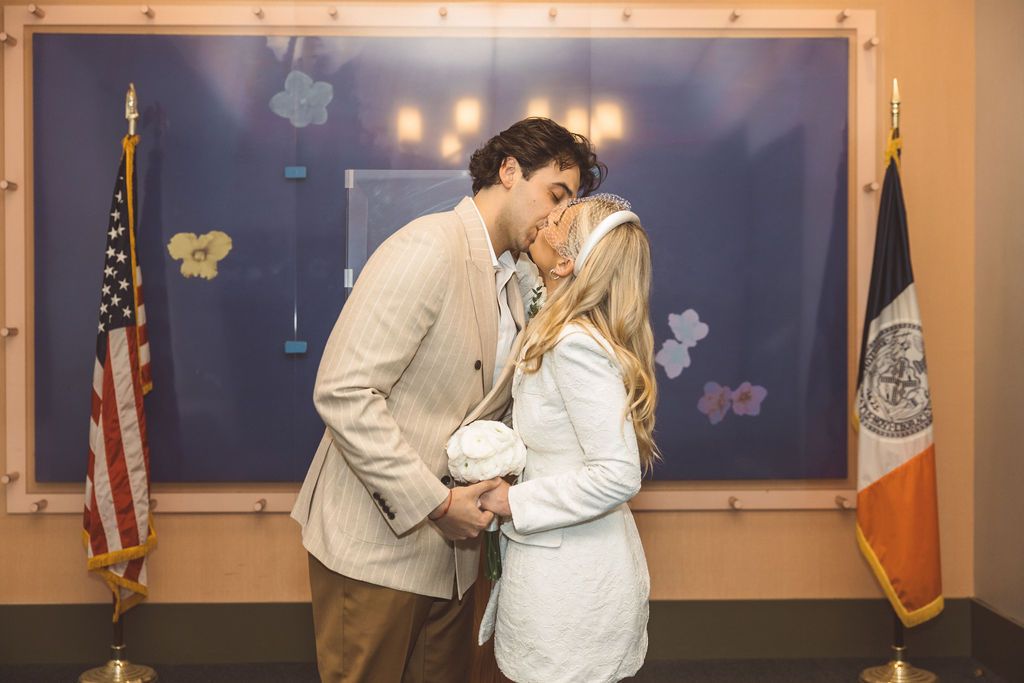 portrait of the bride and groom kissing after their ceremony