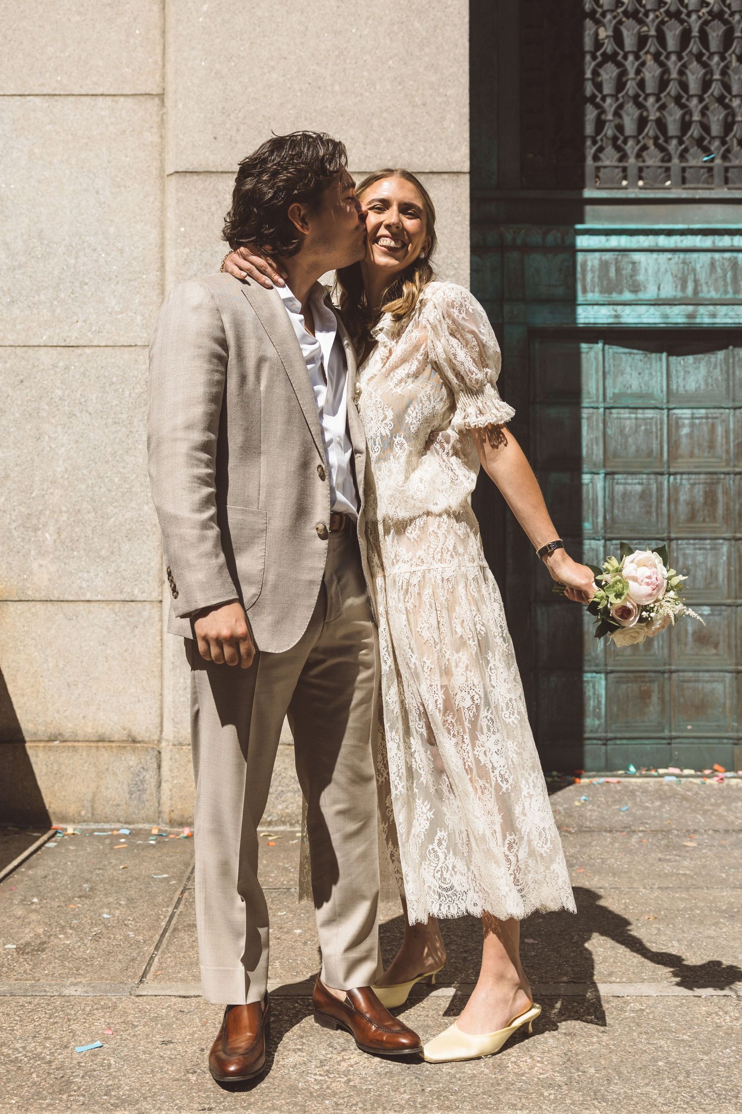 groom kissing the bride on the cheek