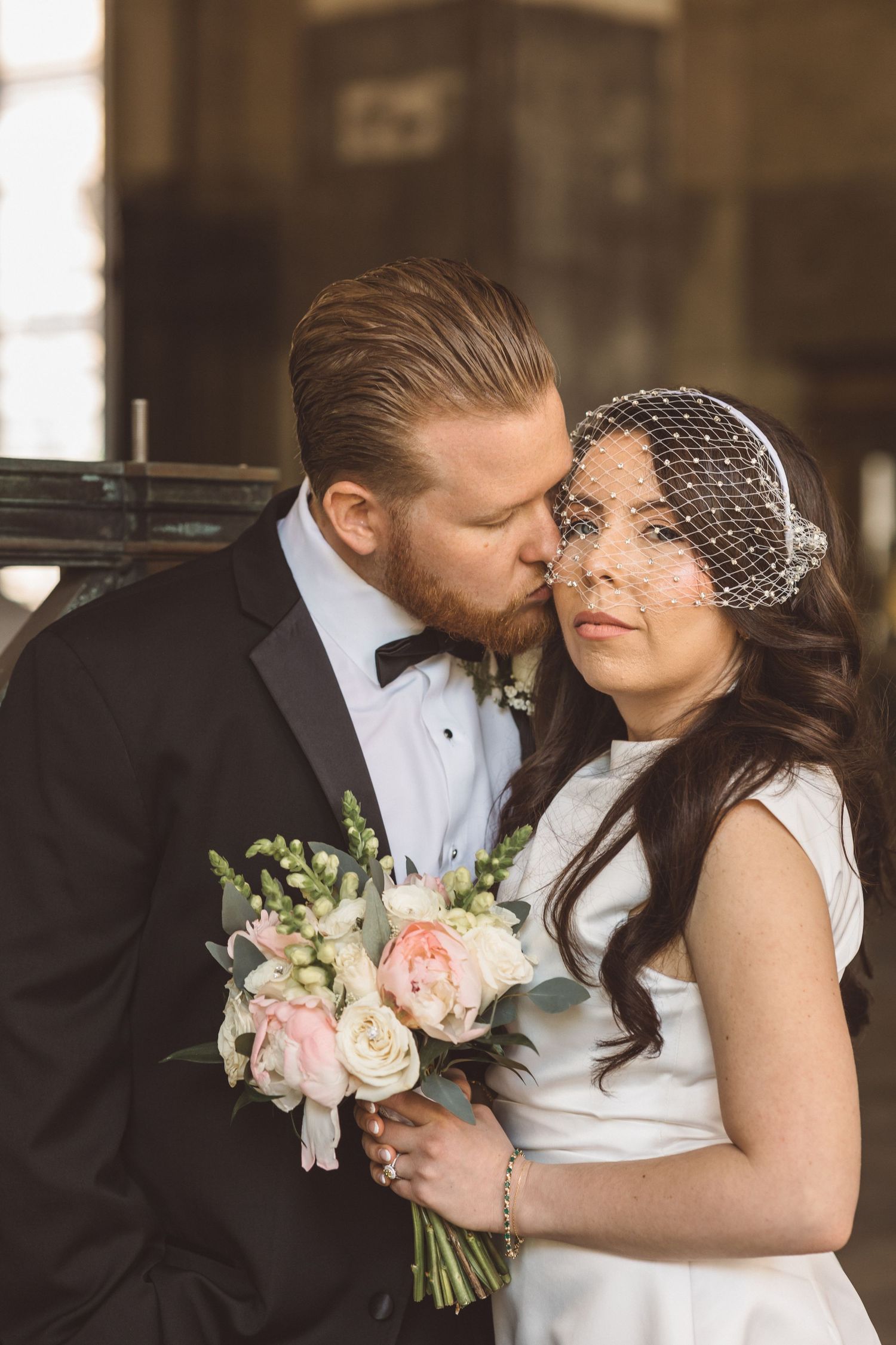 groom kissing the bride on the cheek