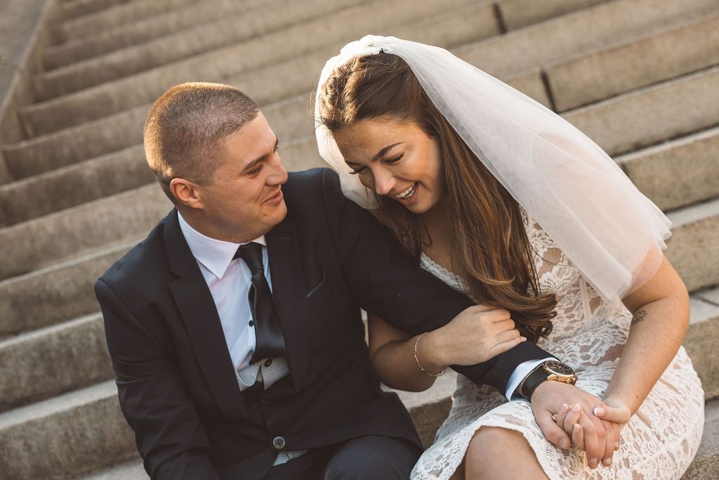 newlyweds laughing with each other during their bridal photos