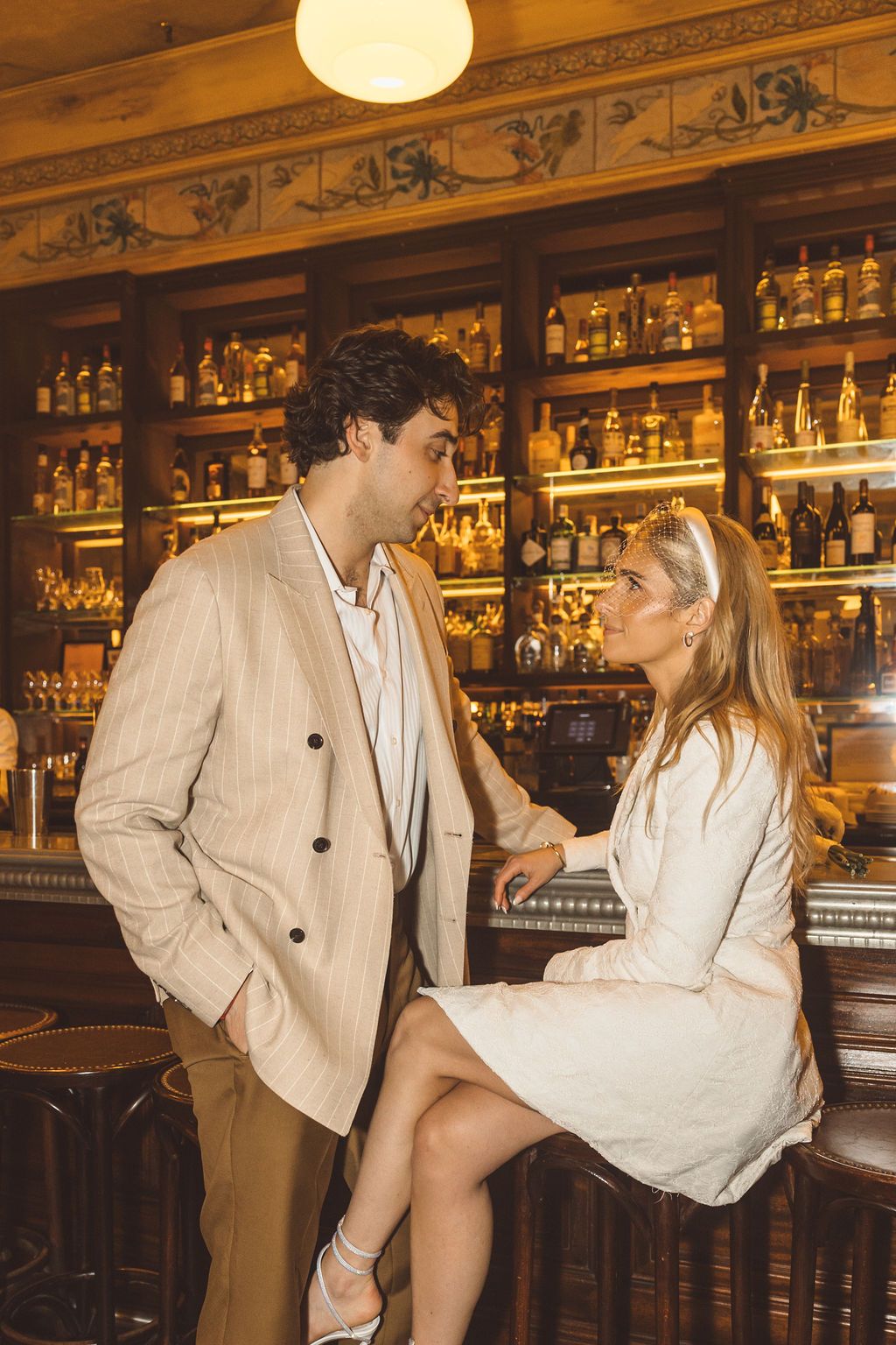 couple celebrating their elopement with a drink at a bar in NYC