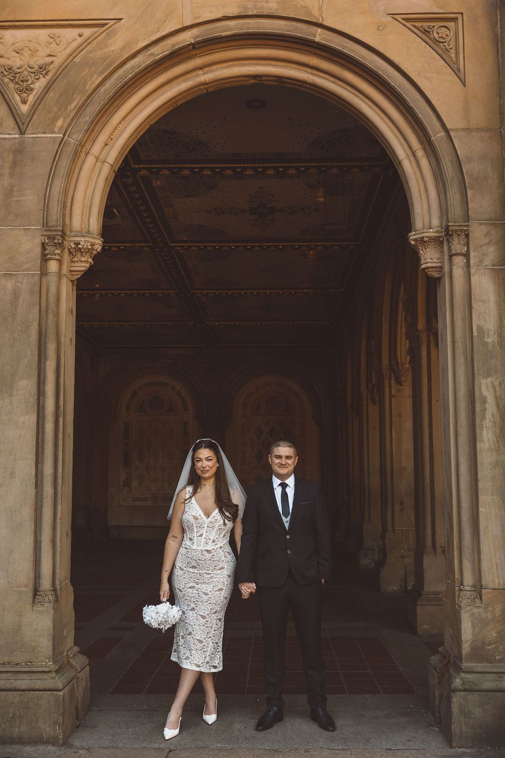 cute picture of the newlyweds smiling at the camera during their bridal portraits