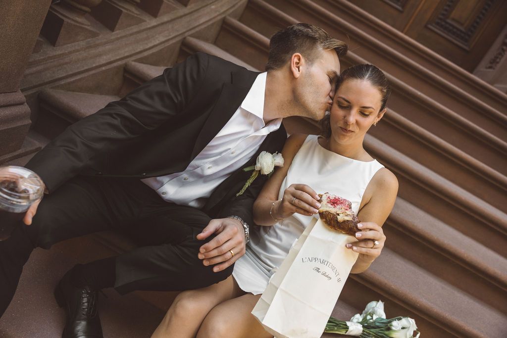 groom kissing the bride on the cheek