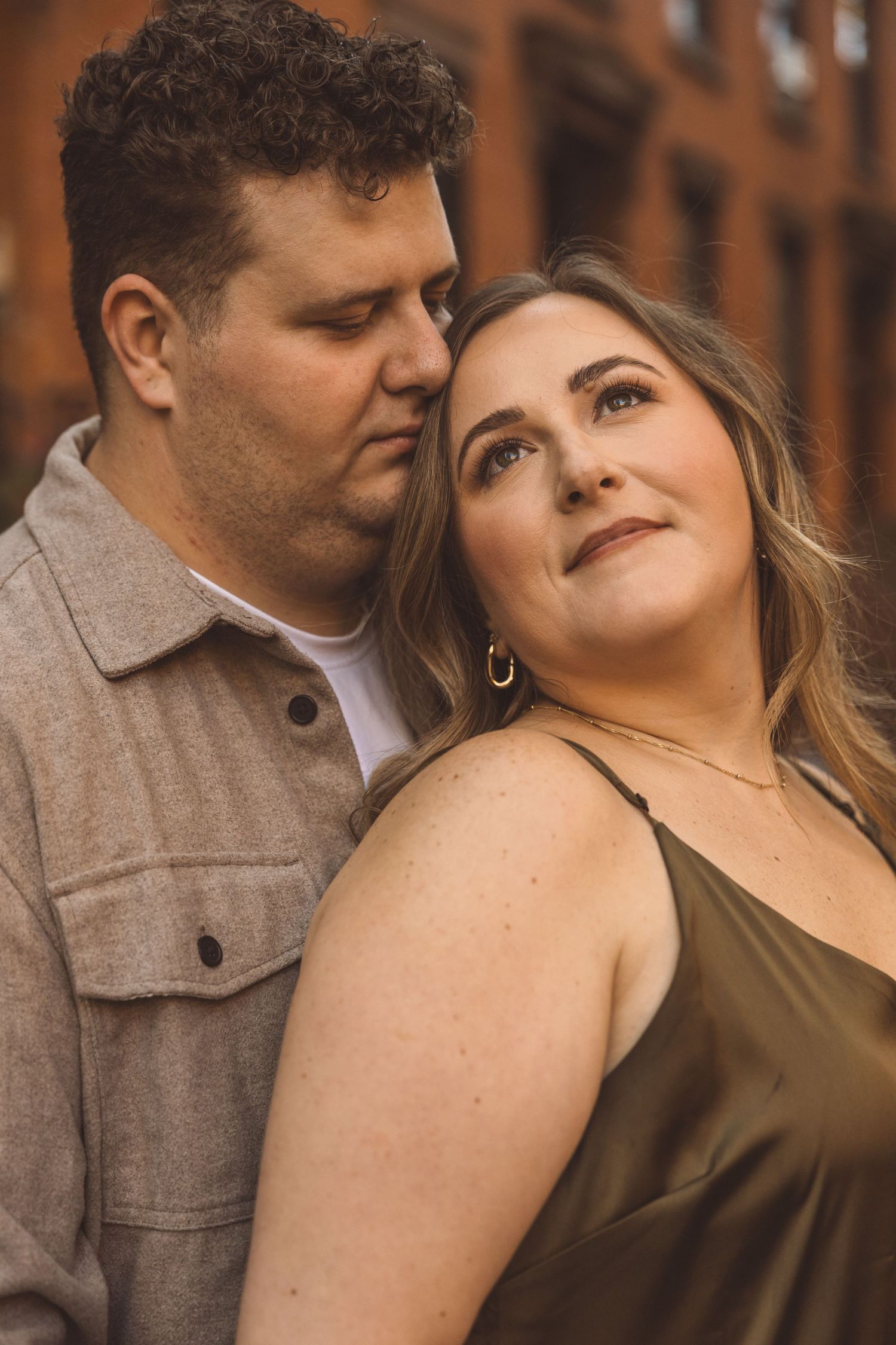 fiance kissing his fiance on the cheek