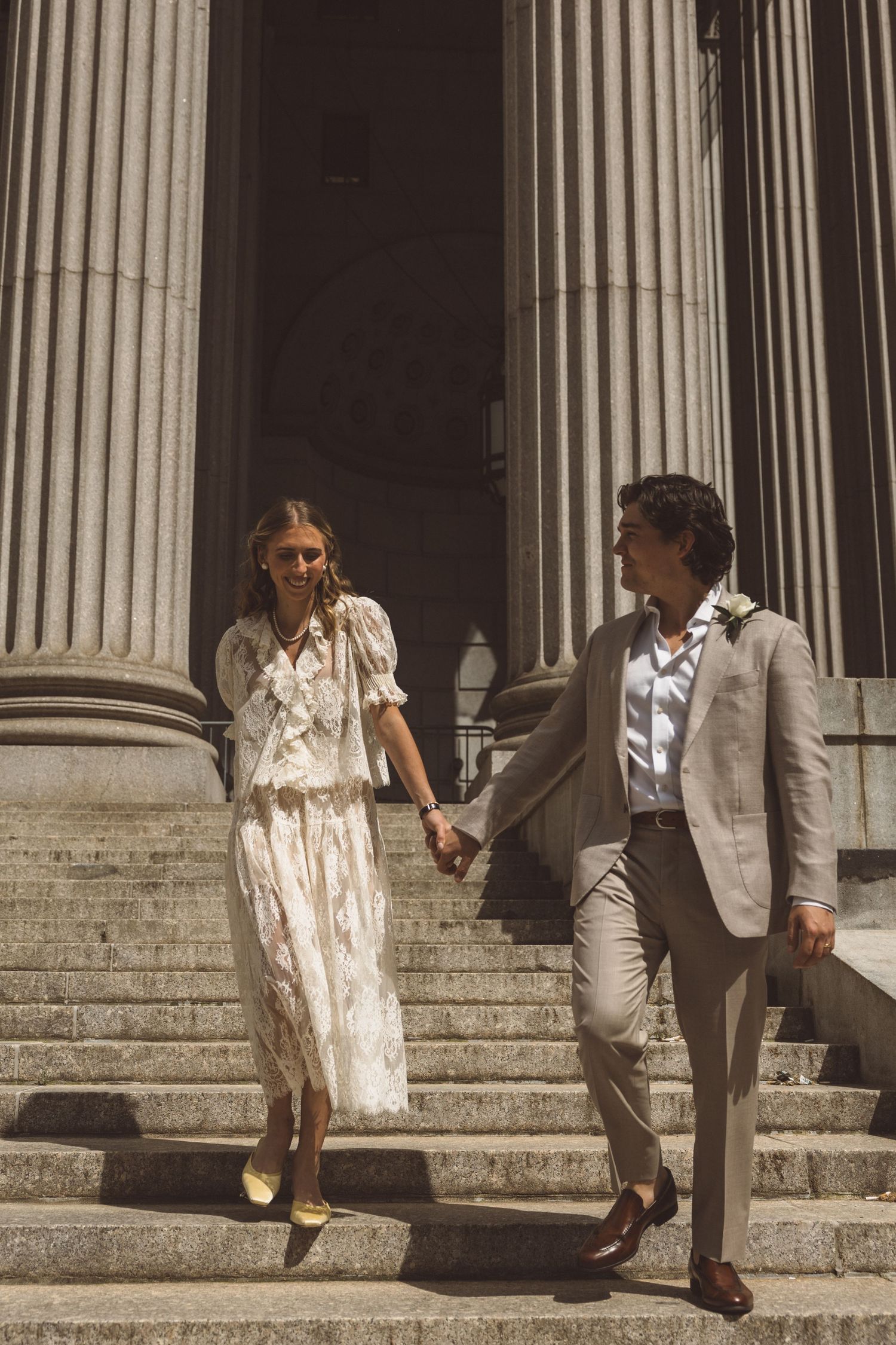bride and groom holding hands during their photoshoot