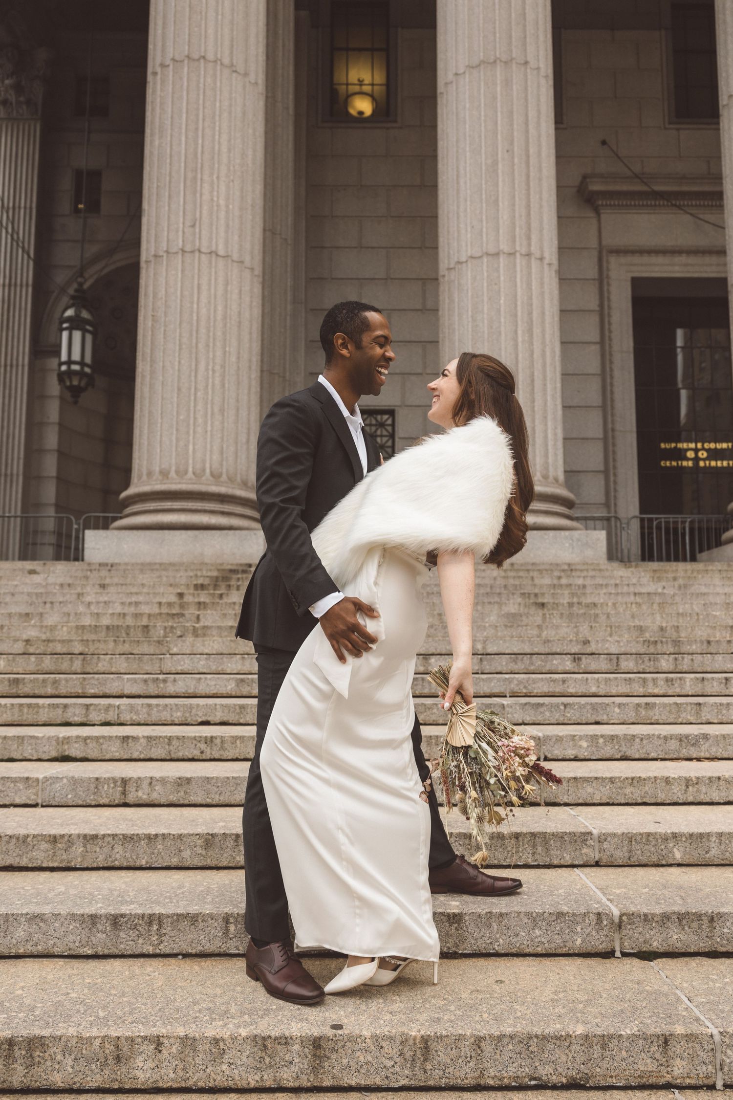 couple smiling at each other during their bridal photos