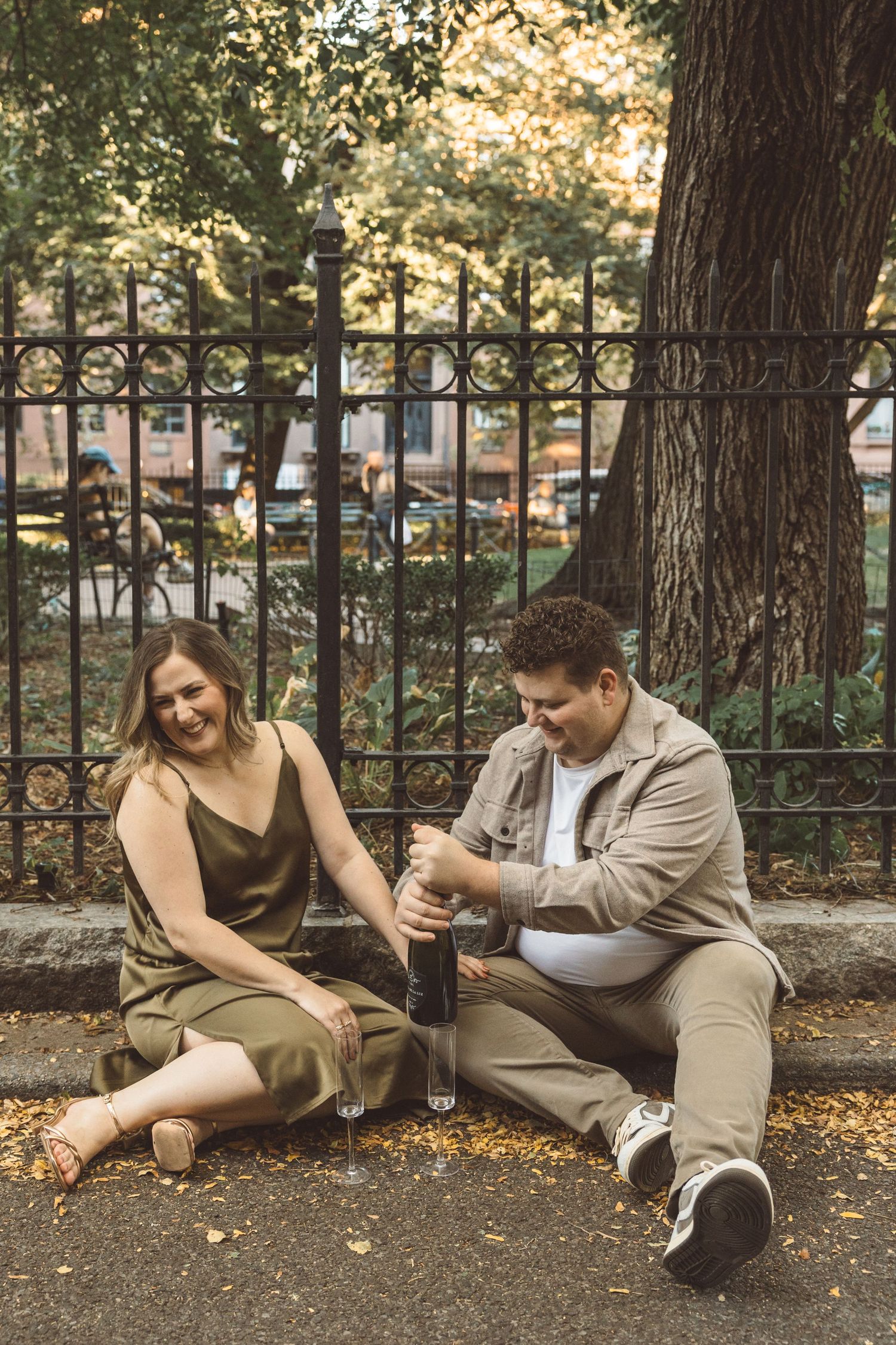 couple celebrating their engagement with champagne