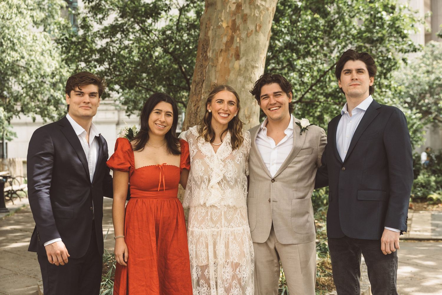 cute picture of the bride and groom with their families after their ceremony