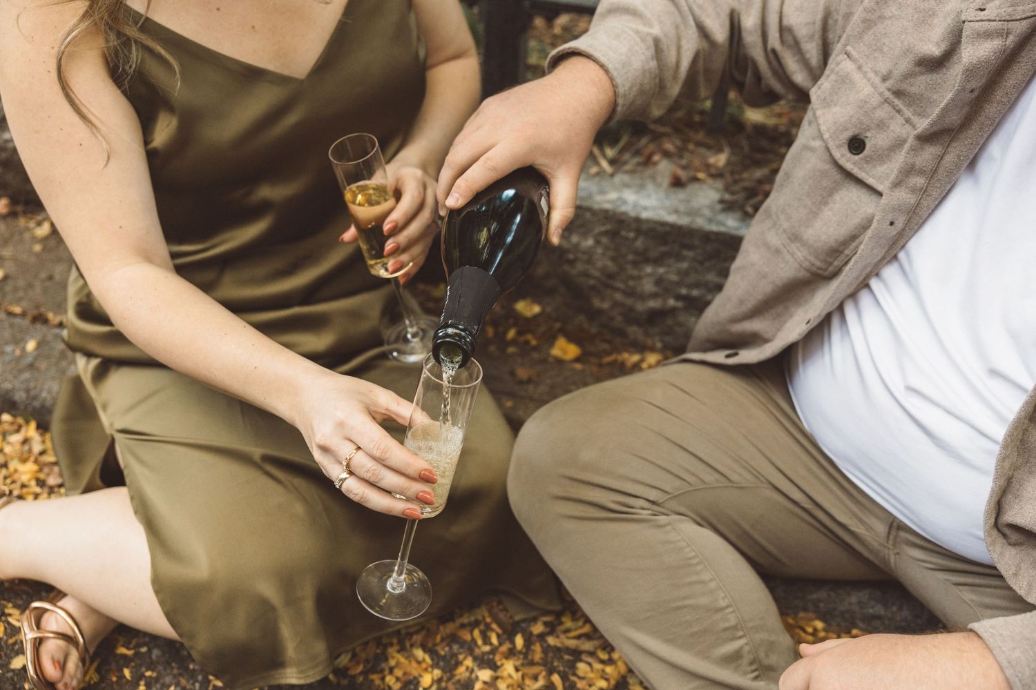 couple celebrating their dream engagement with champagne