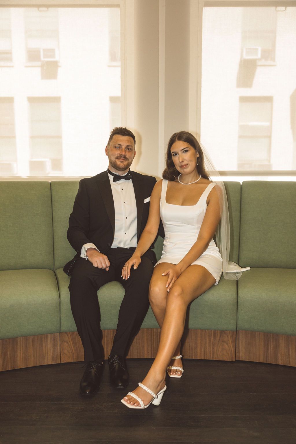 bride and groom smiling at the camera during their photoshoot