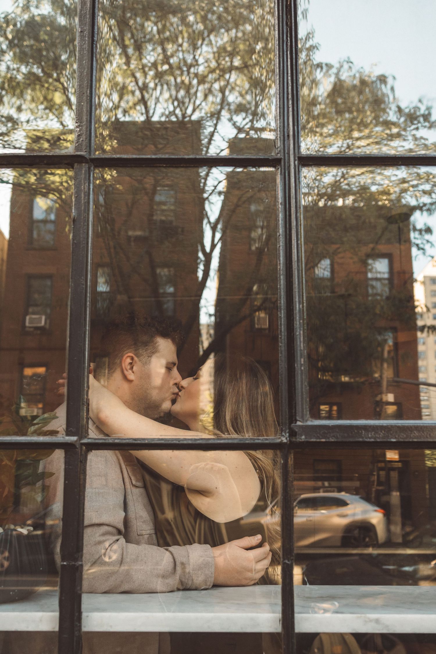 newly engaged couple kissing during their photoshoot
