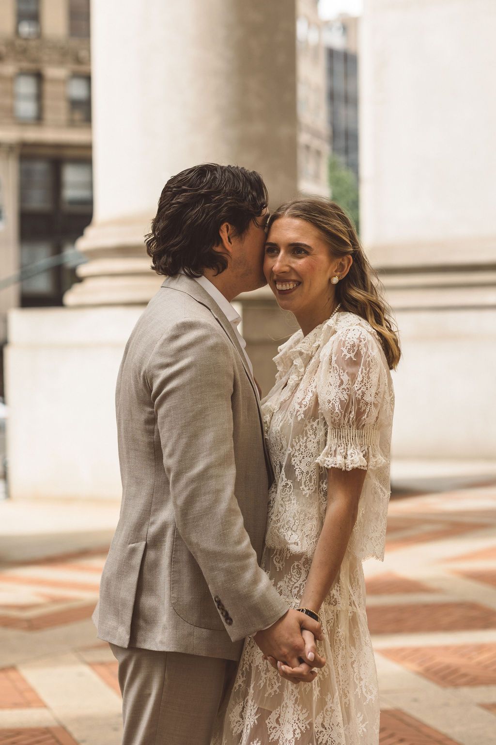 groom kissing the bride on the cheek