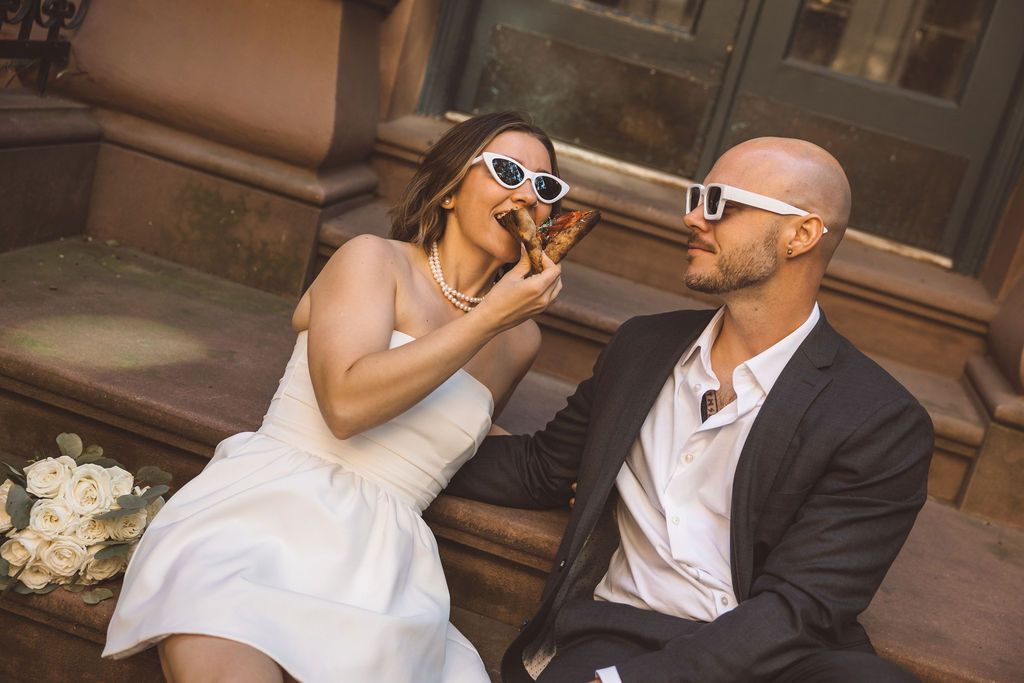 couple celebrating their elopement with pizza