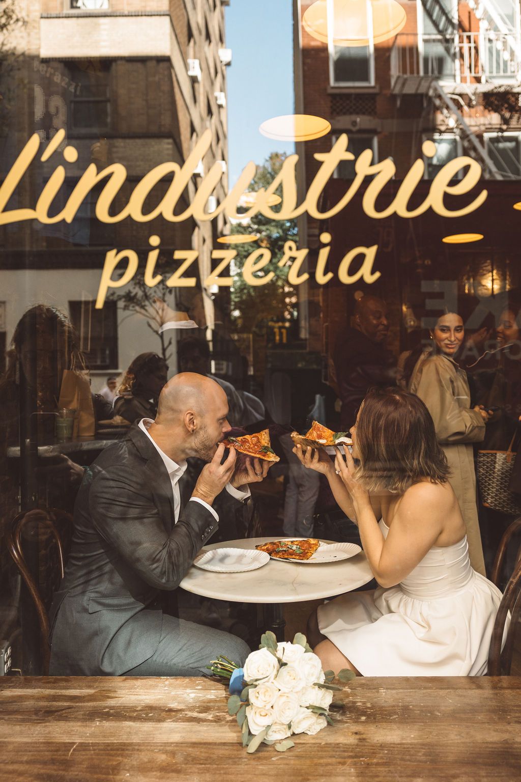 couple celebrating their elopement with pizza