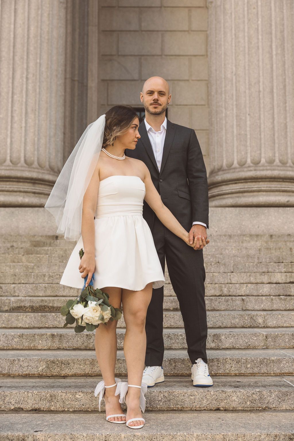 cute portrait of the newlyweds holding hands