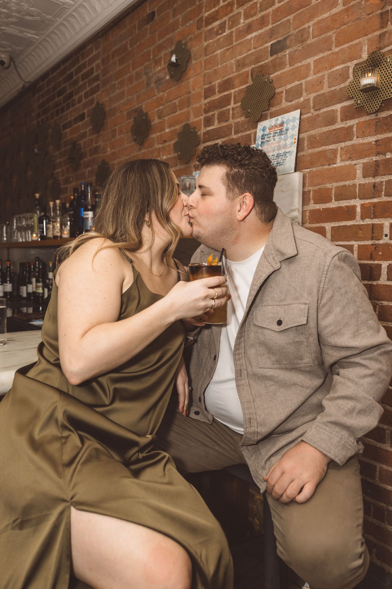 newly engaged couple kissing