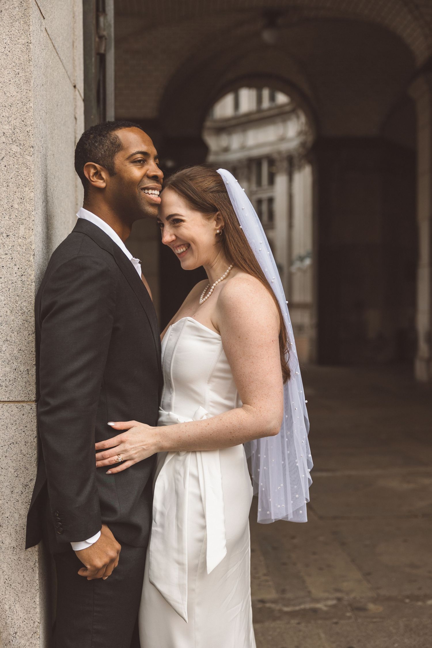 Groom, kissing the bride on the forehead