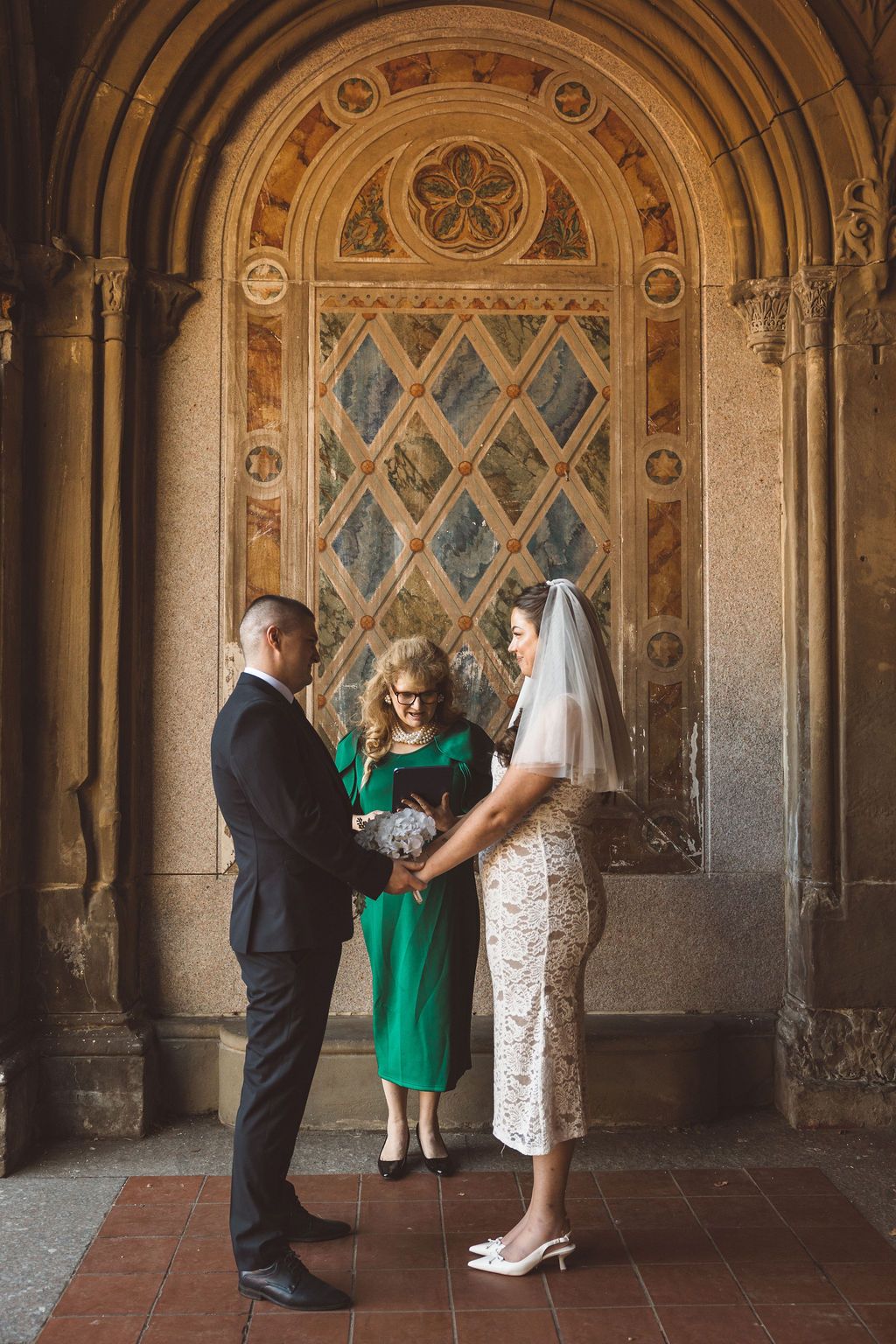 cute picture of the bride and groom holding hands during their ceremony