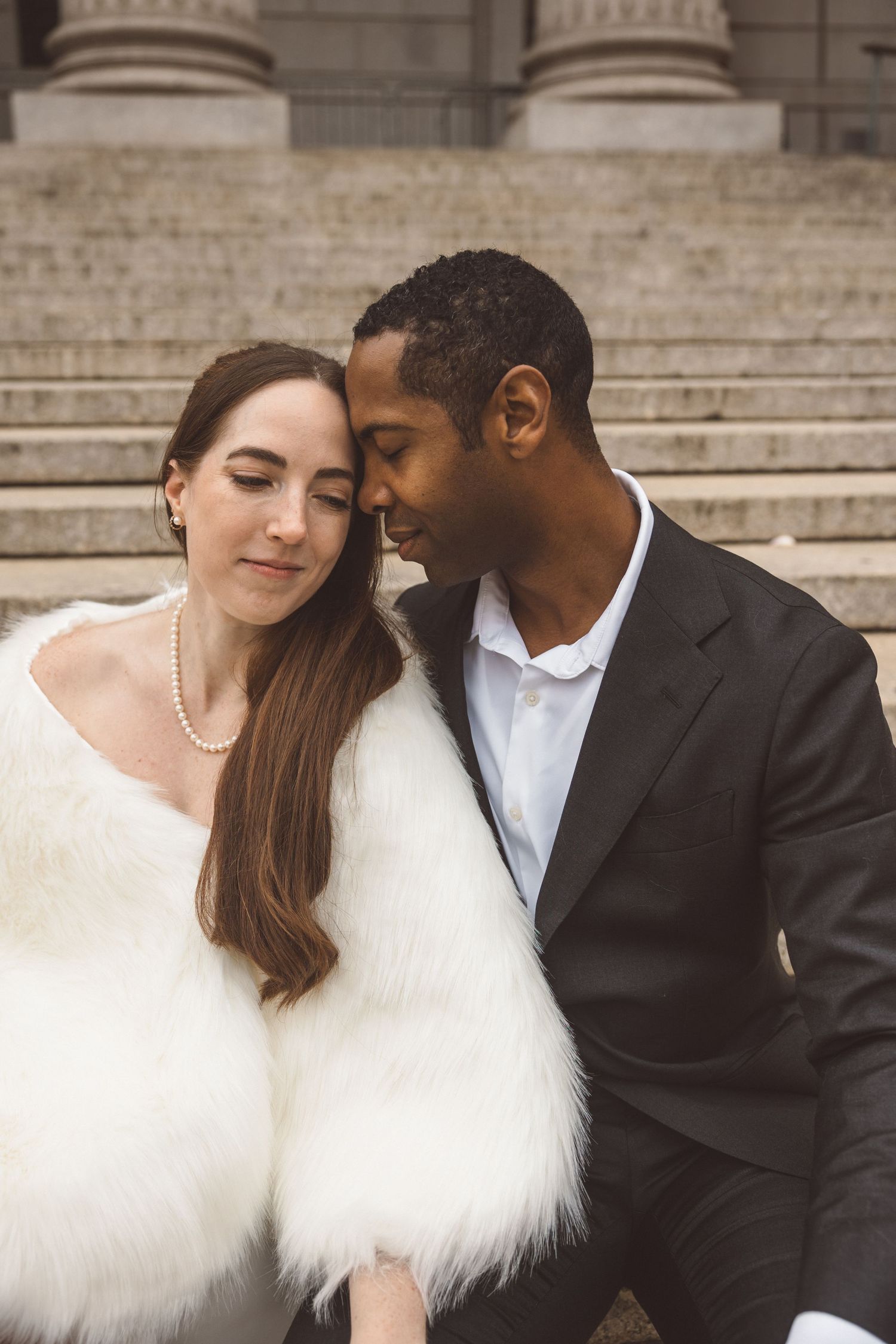 Groom, kissing the bride on the forehead