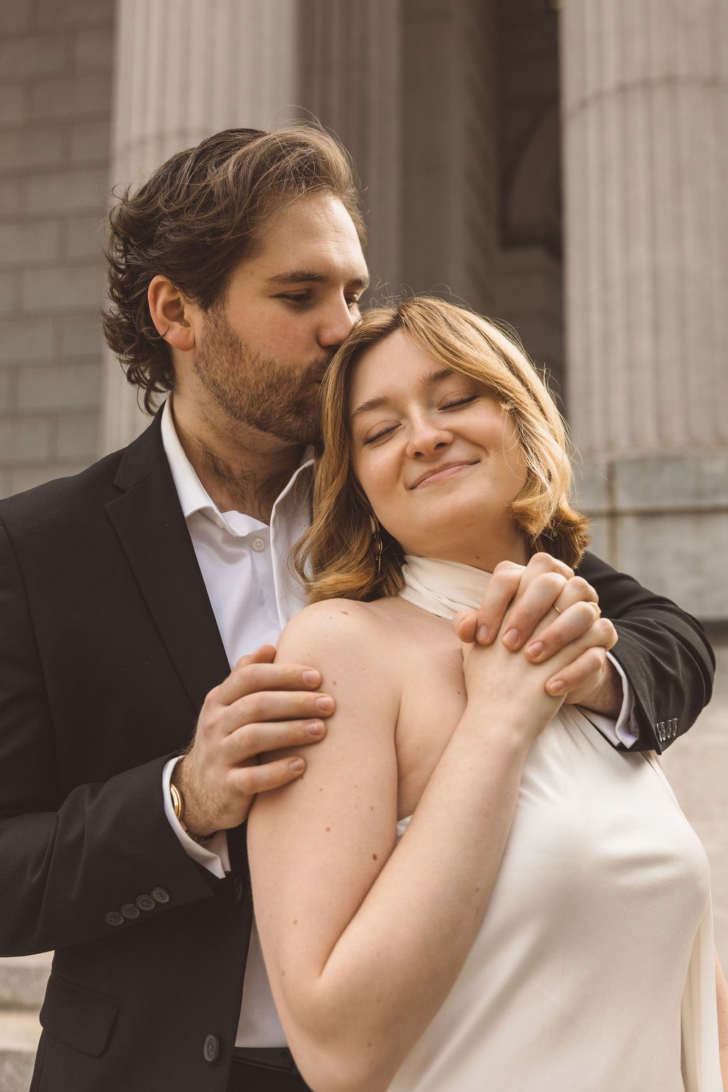 groom kissing the bride on the forehead