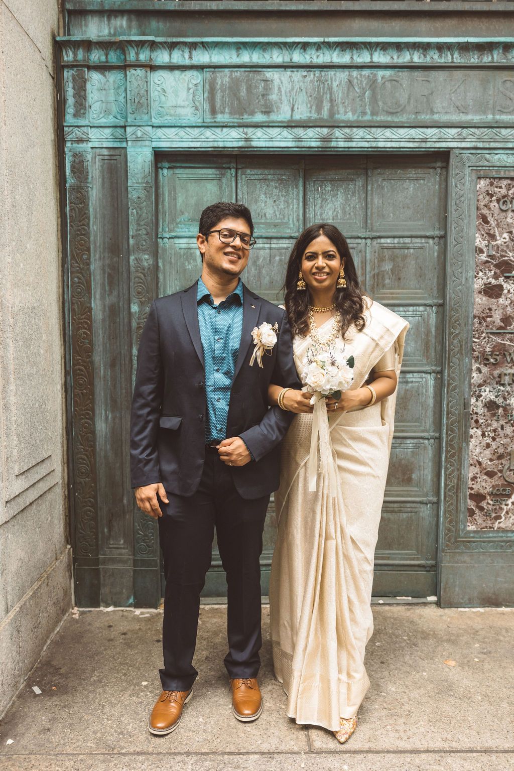 cute picture of the bride and groom smiling at the camera during their photoshoot