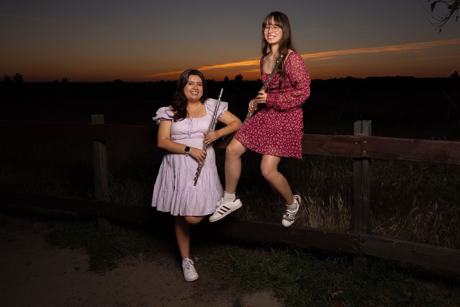 Senior photo session at sunset of two flute players of Clovis North High School at Woodward park in Fresno California.
