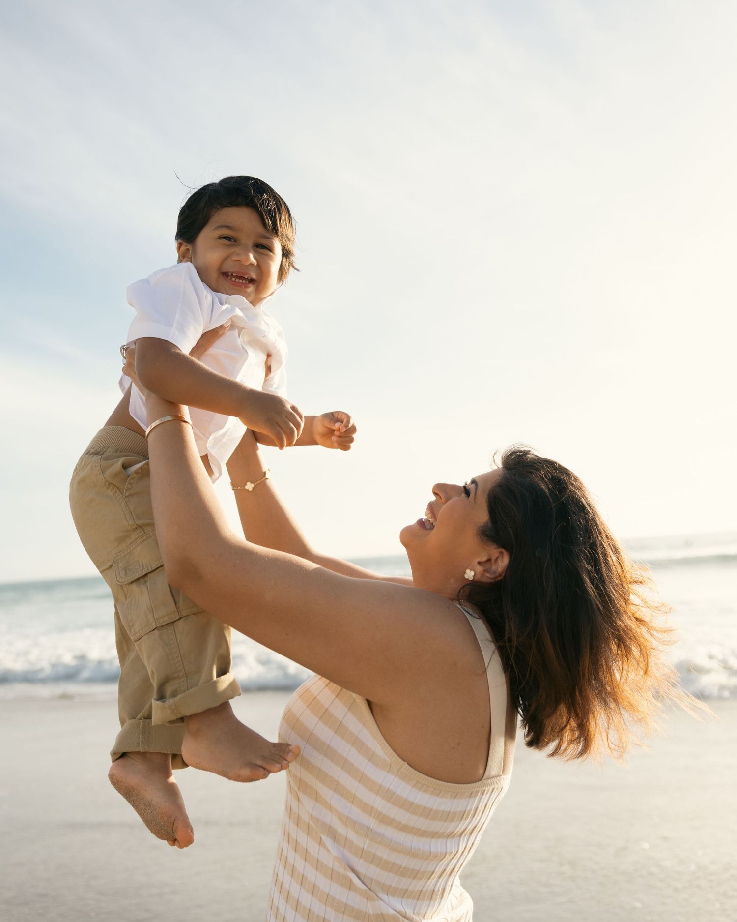 mother playing with her son in the sunset at Del Mar beach