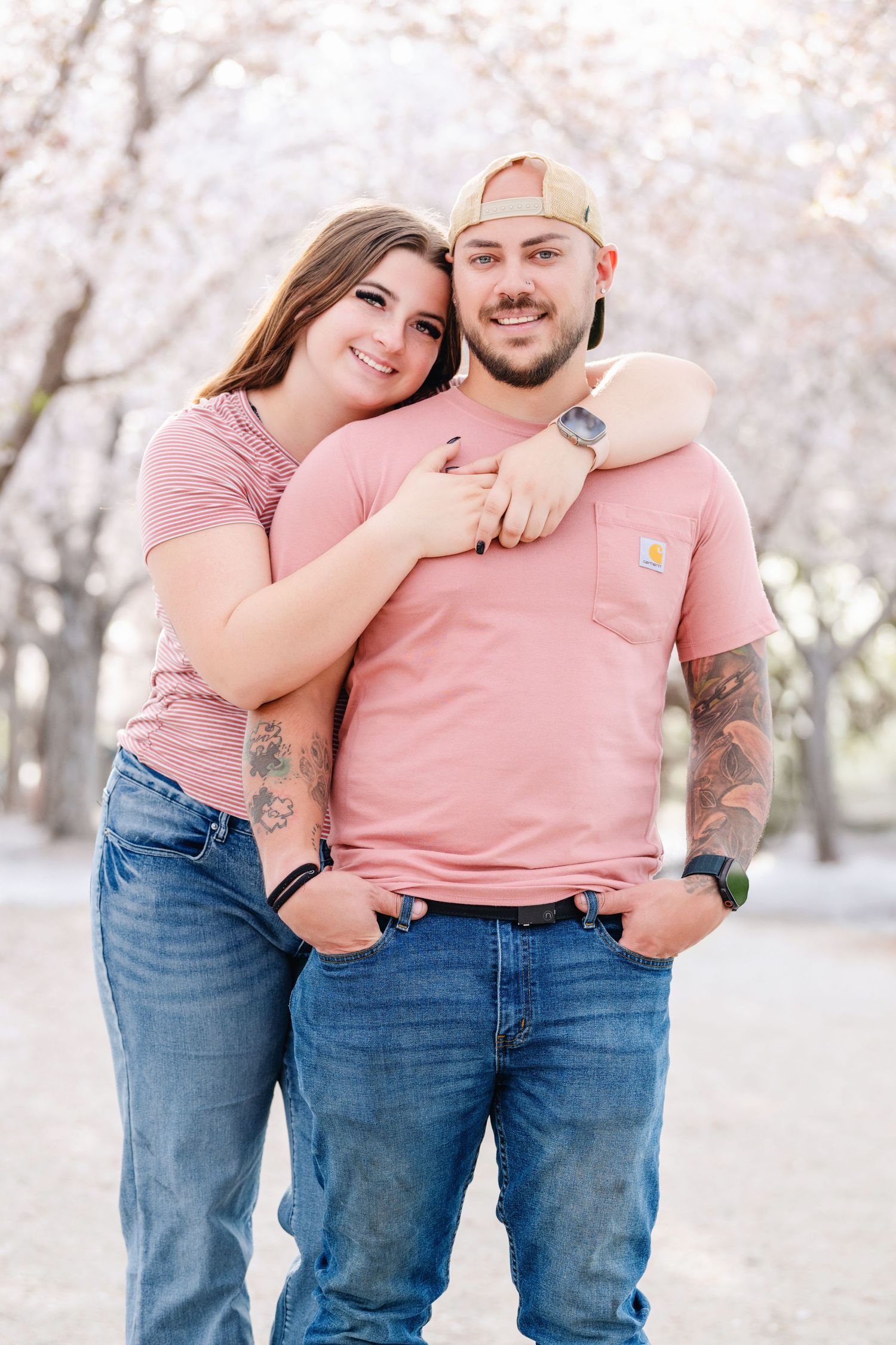 Young couple portrait beneath cherry blossoms at the Utah State Capitol building during outdoor family session