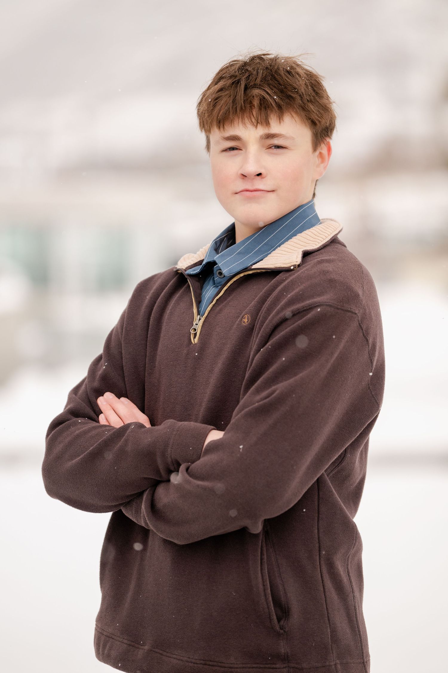 Teenage boy portrait with folded arms during winter outdoor photography session