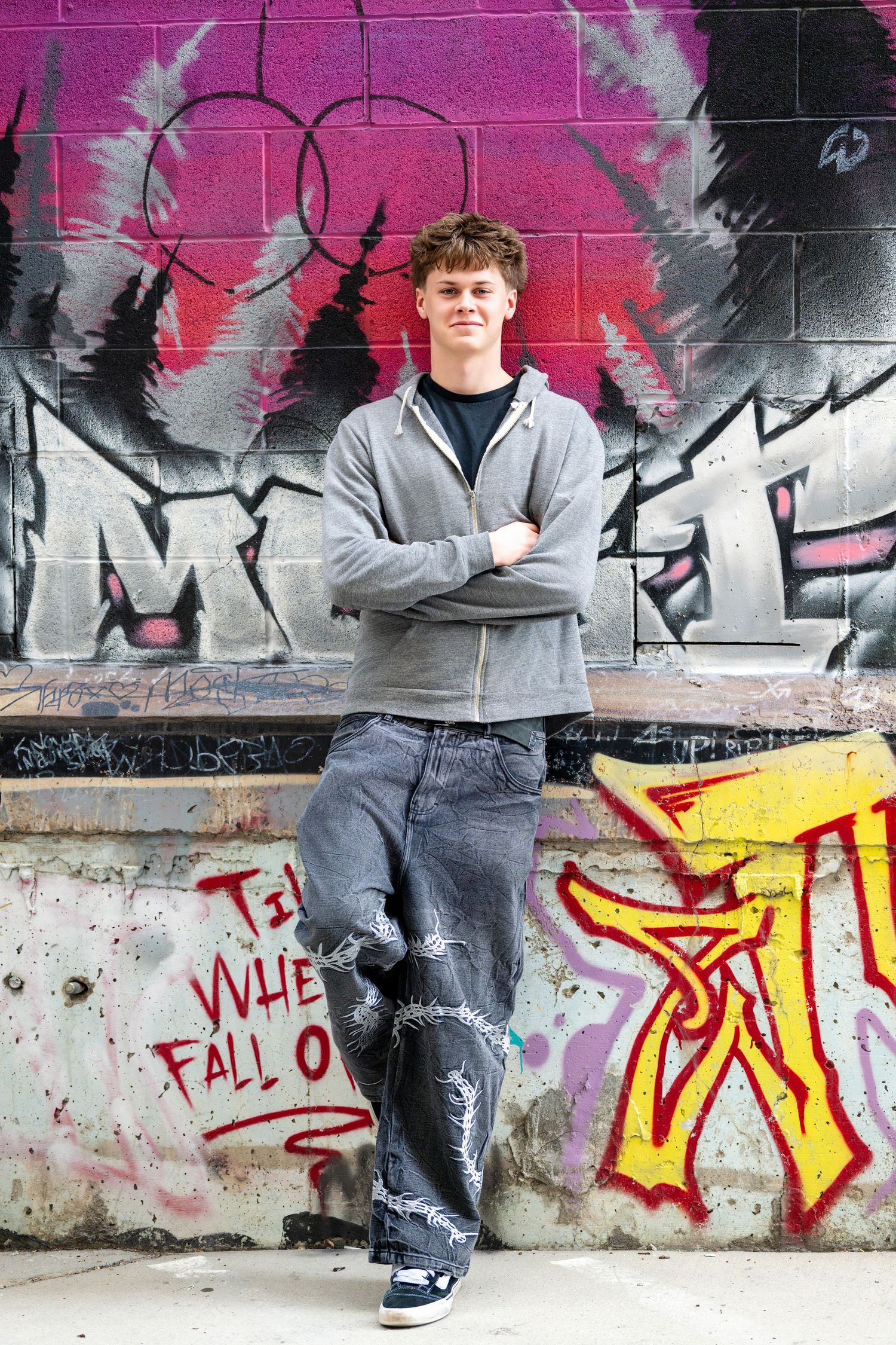 Urban senior portrait with graffiti wall background for high school senior photography in Utah