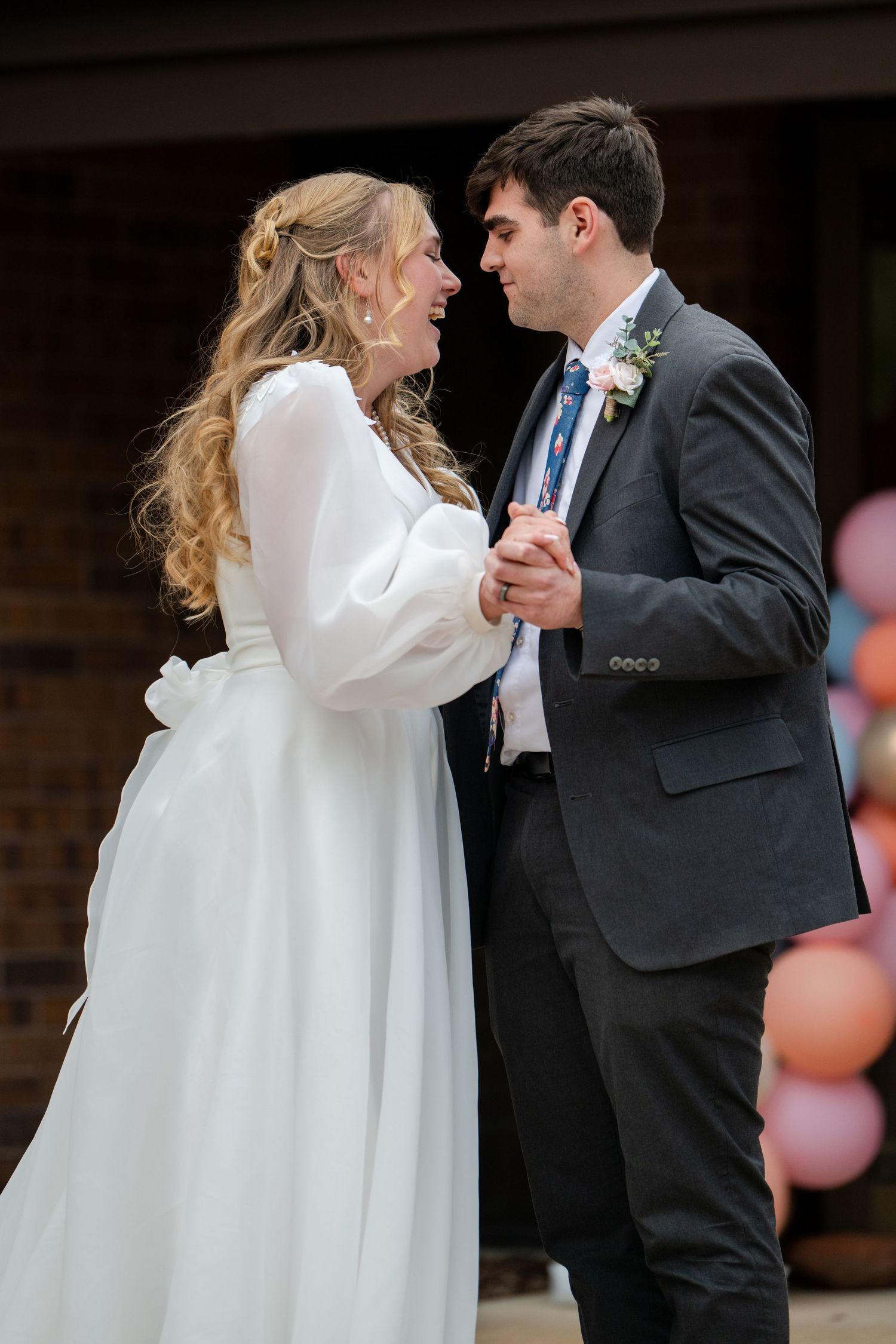 Bride and groom sharing first dance during elegant indoor wedding reception celebration