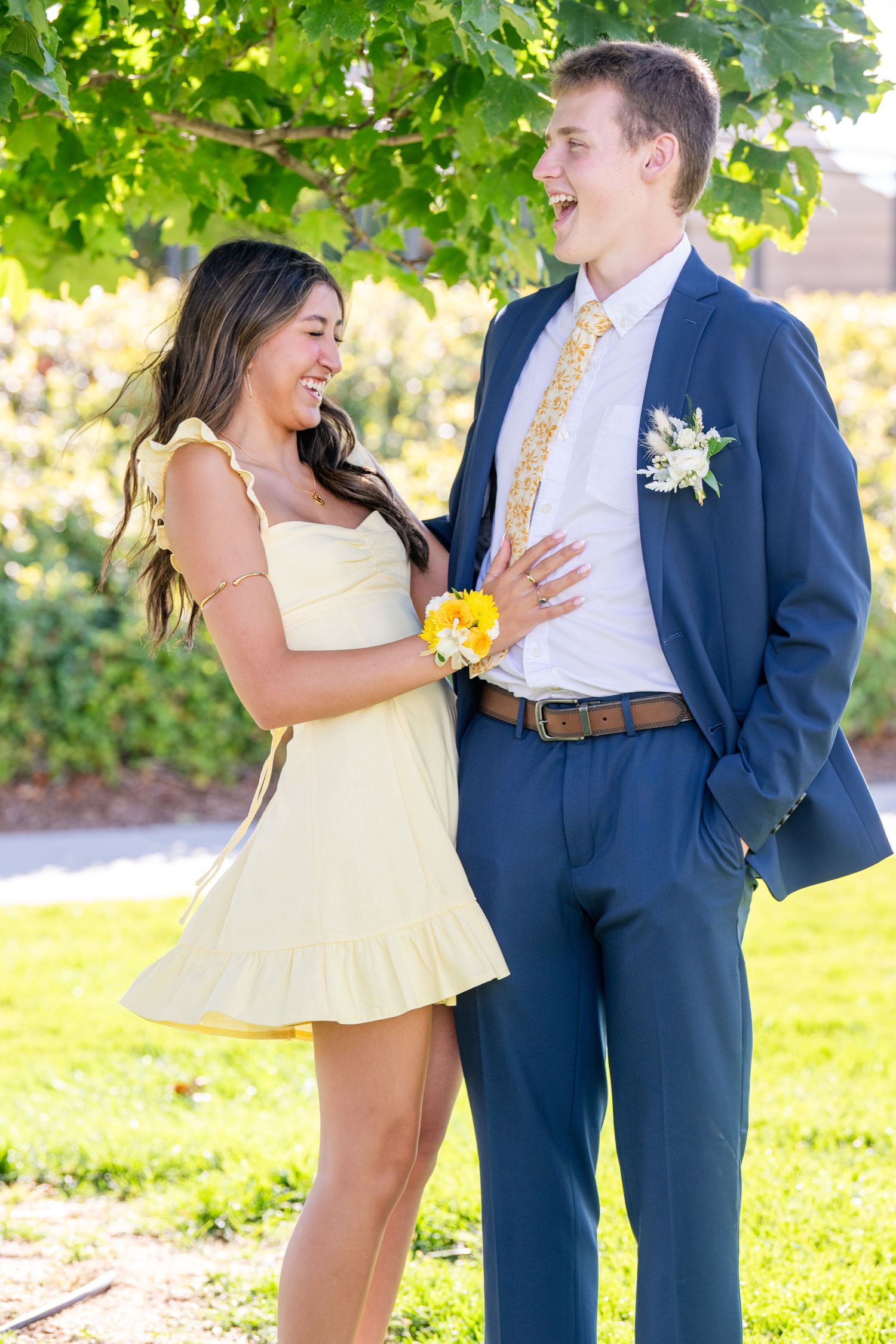 Bountiful Homecoming couple smiling together outdoors with yellow dress and blue suit