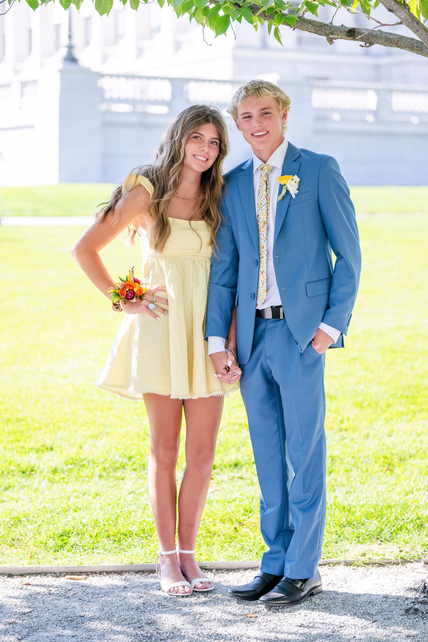 Bountiful Homecoming couple standing together outdoors with yellow dress and blue suit