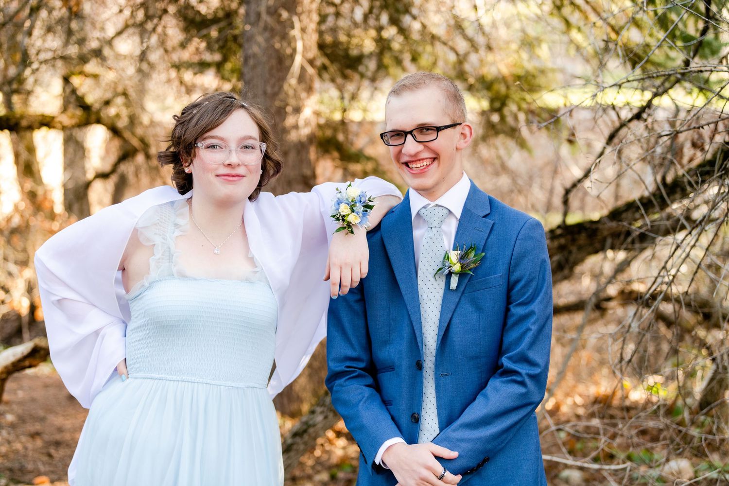 Woods Cross Prom couple smiling outdoors in formal attire with soft natural background
