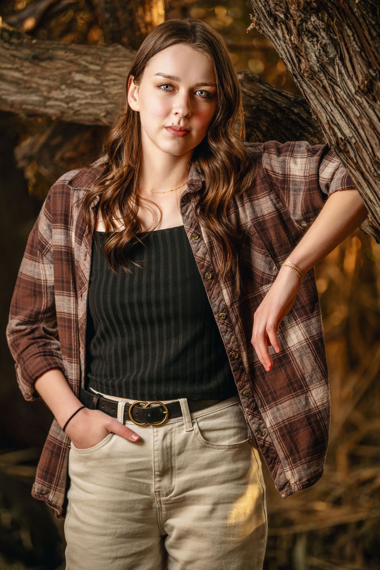 Outdoor female portrait with plaid shirt and autumn colors during golden hour session