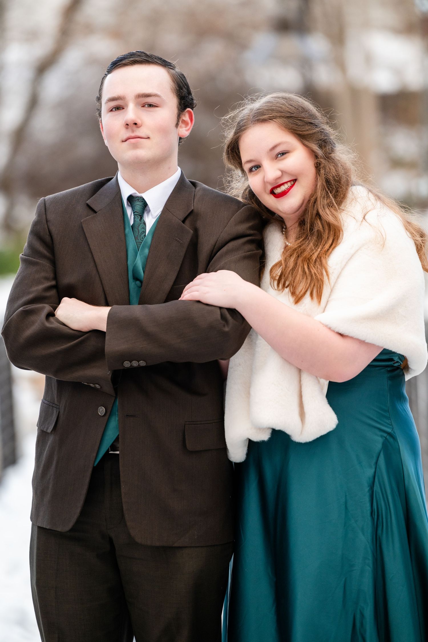 Woods Cross Sweethearts dance Couple posing together with playful expression in formal attire outdoors