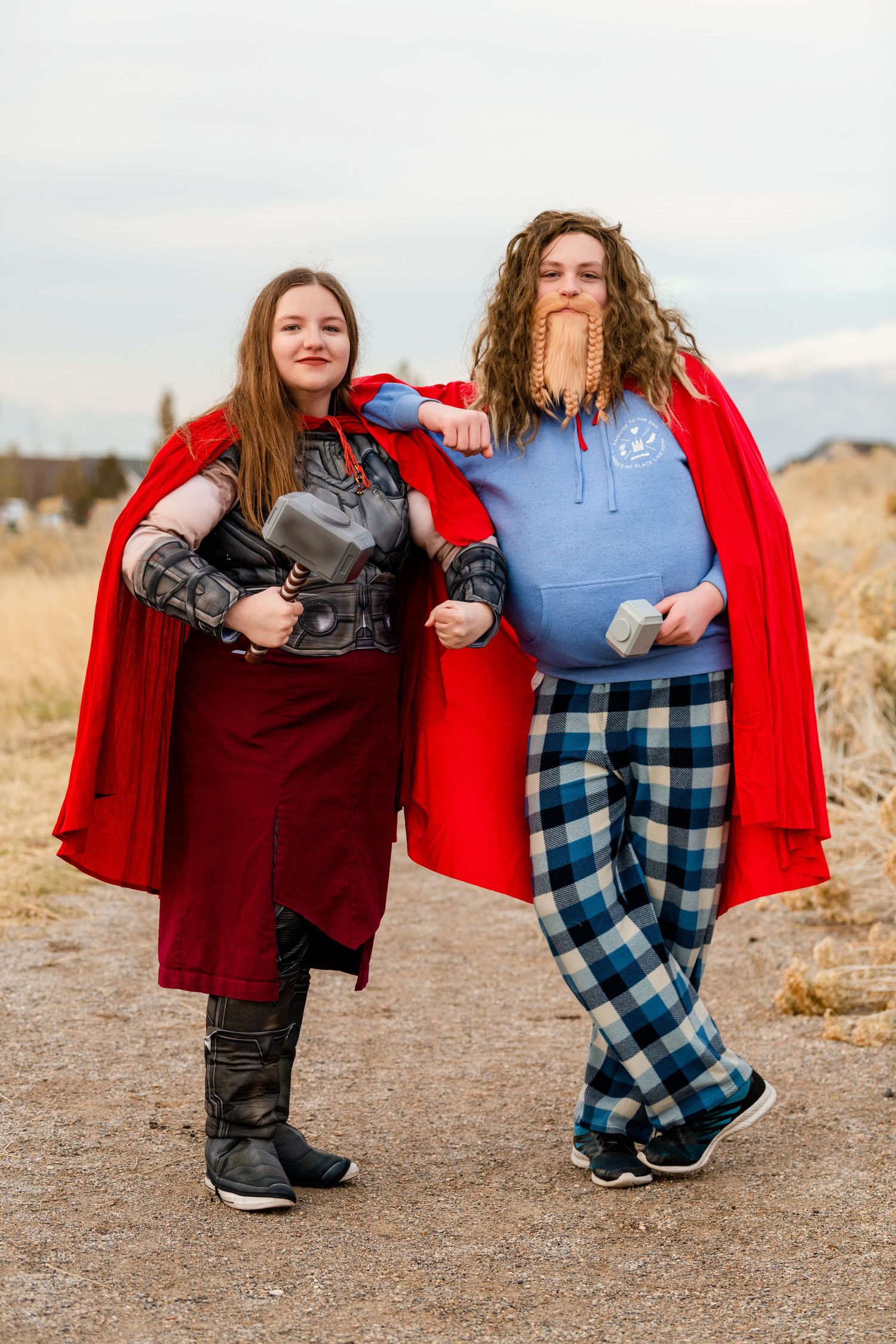 Two teens in Thor themed outfits with playful pose in natural setting for Woods Cross Sadie Hawkins dance