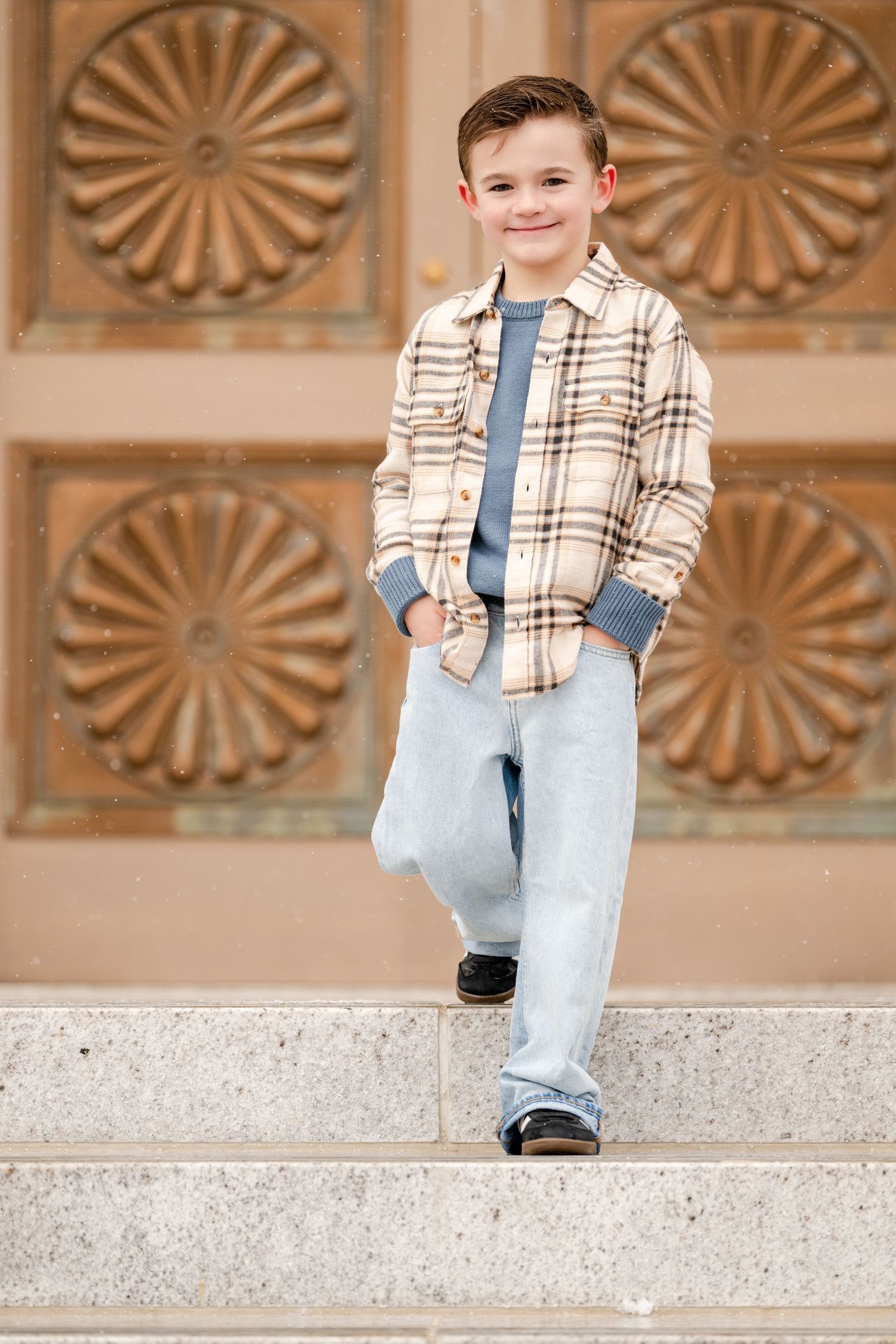 Young boy portrait on stone staircase at the Bountiful Utah Temple during outdoor family photography session