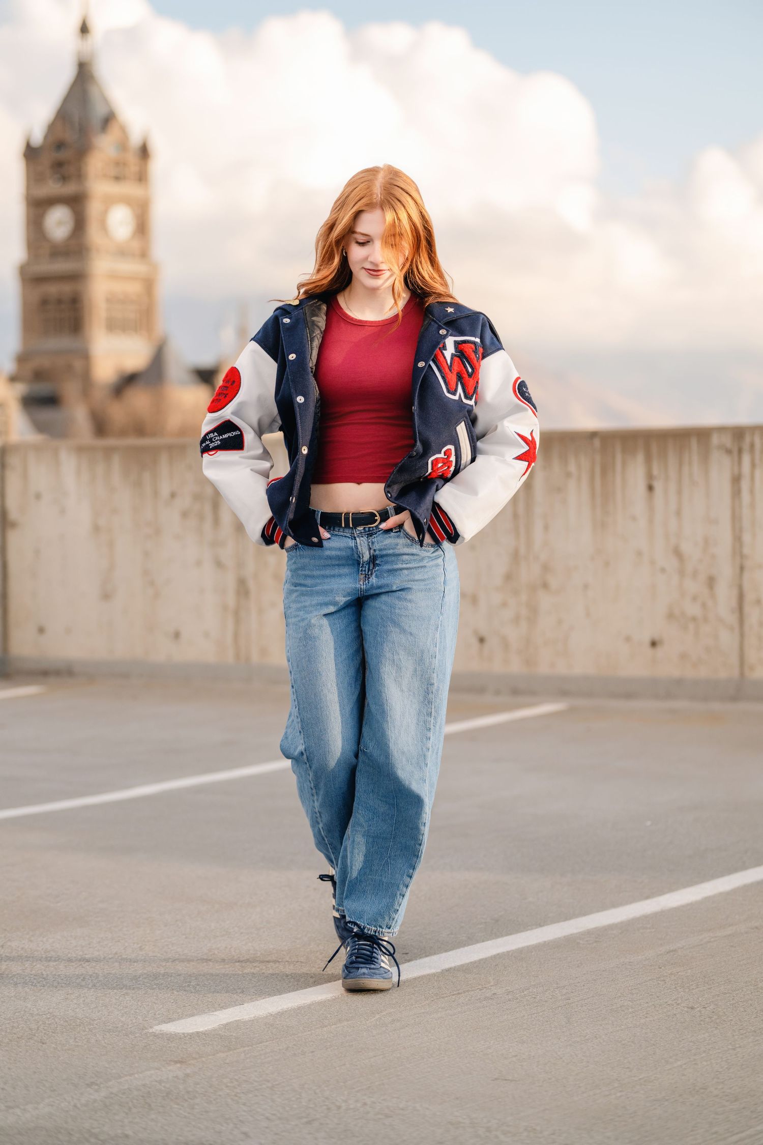 Senior girl walking on rooftop in Salt Lake City with casual outfit and soft urban sunset light