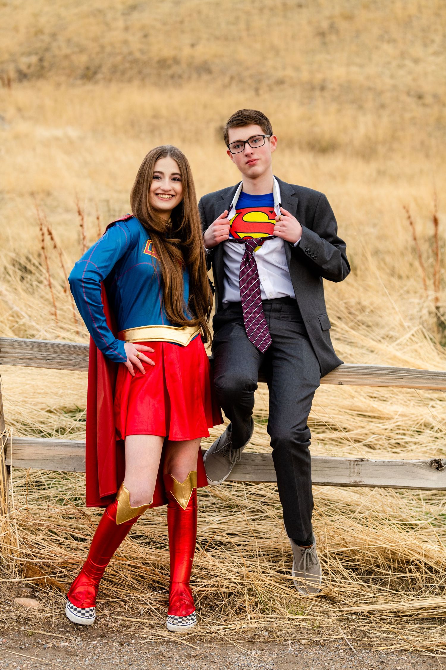 Two seniors in Captain America themed outfits with playful pose in natural setting for Woods Cross Sadie Hawkins dance