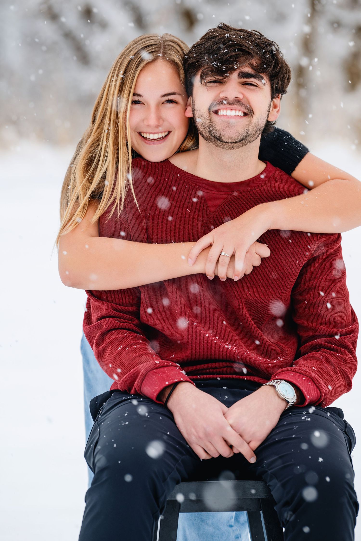 Engagement photo in North Salt Lake, Utah snow with couple smiling and embracing with soft winter light and romantic feel