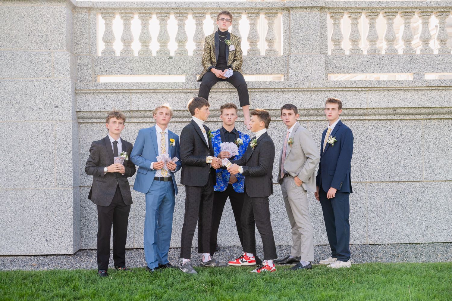 Group of boys in suits posing on at the Salt Lake Capitol with one seated above others