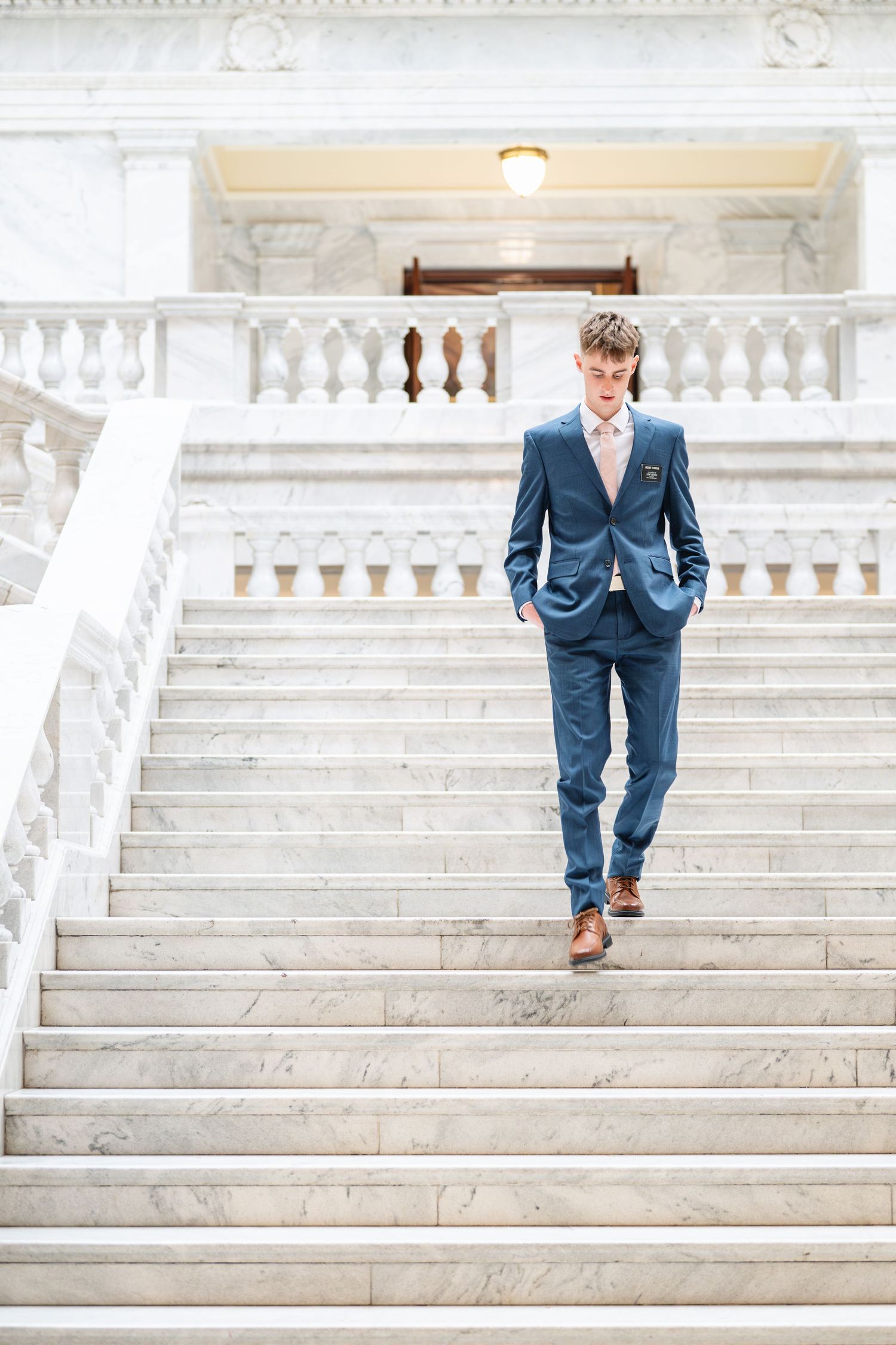 Young missionary portrait on grand marble staircase at the Utah State Capitol during LDS missionary photography session