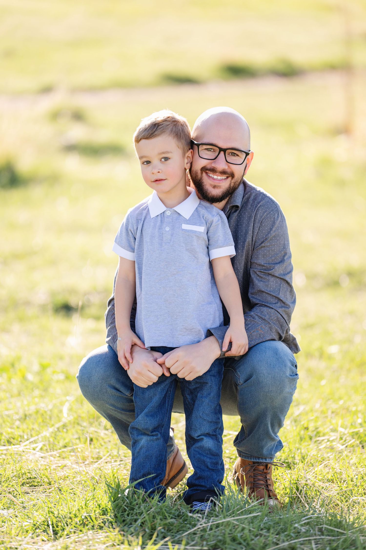 Father and son outdoor portrait in open field during family photography session