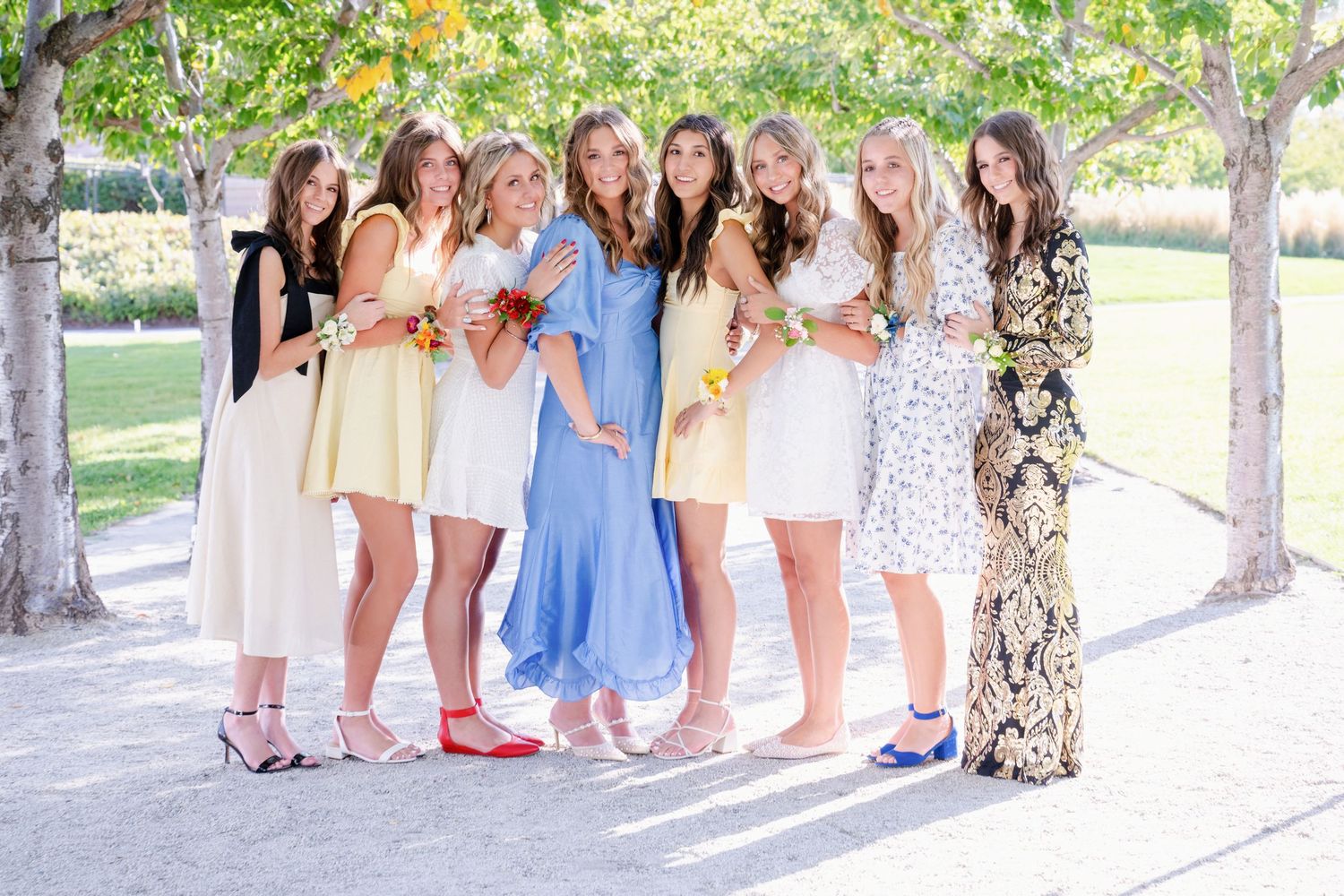 Group of high school senior girls posing together under the Utah State Capitol trees