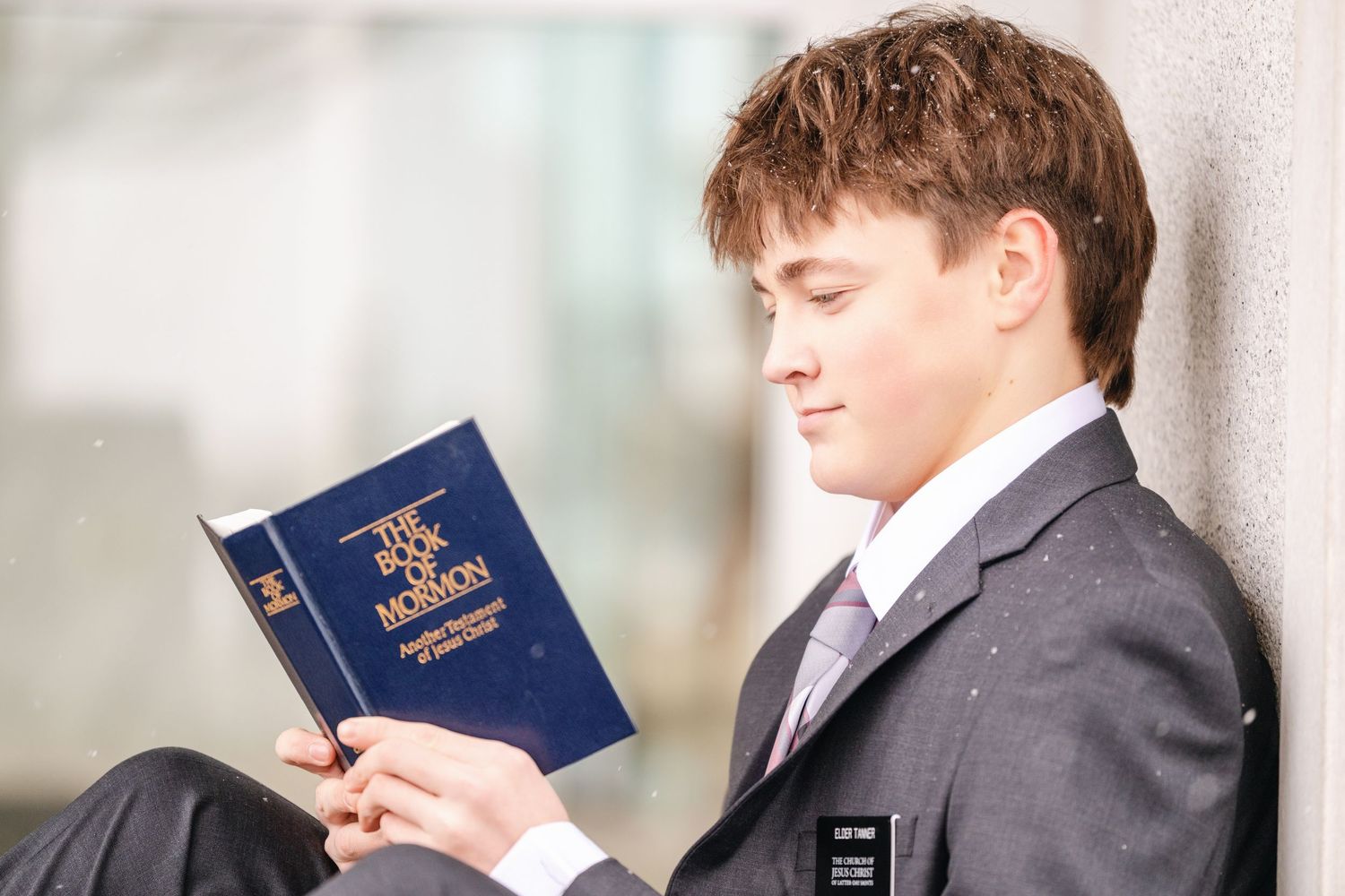 Young LDS missionary reading scriptures during outdoor missionary portrait session in Utah