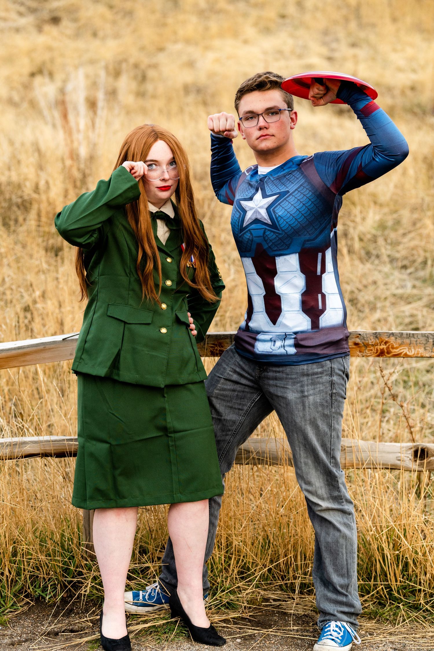 Two teens in Captain America themed outfits with playful pose in natural setting for Woods Cross Sadie Hawkins dance