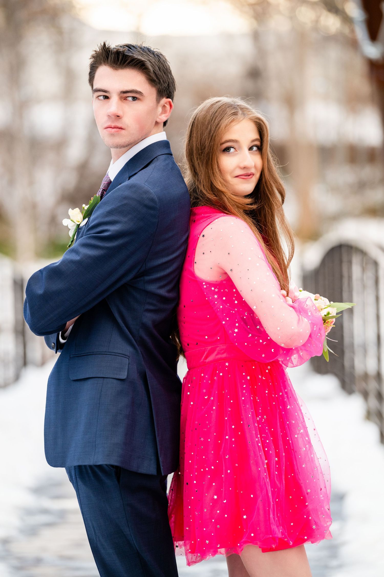 Woods Cross Sweethearts dance couple standing back to back in formal outfits with confident pose in winter setting